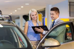 Car salesman assessing resale value