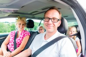 family driving in car with seat belt fastened