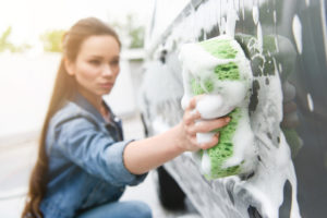 attractive woman washing your car