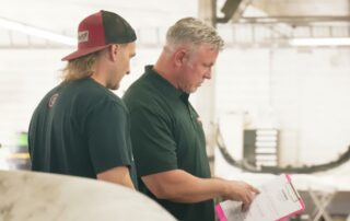 Orlando Auto Body team reviewing collision repair plans before vehicle repairs begin
