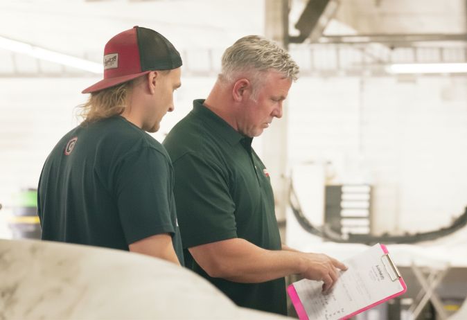 Orlando Auto Body team reviewing collision repair plans before vehicle repairs begin
