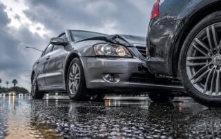Arizona monsoon season collision on a wet roadway showing two vehicles involved in a fender bender