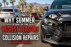 Summer collision repairs in Arizona with damaged vehicle on a busy Phoenix roadway