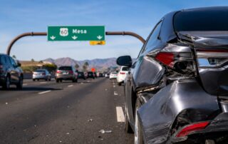 Rear-end collision on US 60 in Mesa with damaged vehicle awaiting collision repair after a freeway accident.